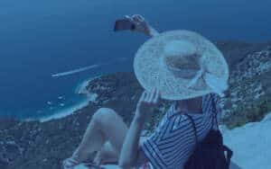 woman taking selfie on vacation - posting on social media